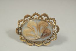 A VICTORIAN BROOCH inset with hair and seed pearls. Inscribed and dated ,1843.