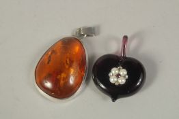A SILVER AND AMBER PENDANT and a PENDANT SET WITH PEARLS.