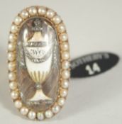 A GOOD GEORGIAN GOLD OVAL RING with enamel and surrounded by seed pearls. Provenance: bears Sothebys