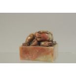 A CHINESE CARVED SOAPSTONE DOG SEAL. 5.5cms x 4.5cms.