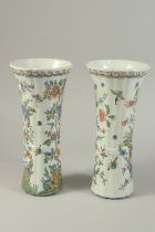 A PAIR OF DUTCH FANCY POLYCHROME POTTERY VASES, painted with birds and butterflies. 12ins high.