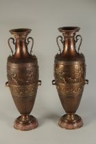 A SUPERB PAIR OF TWO-HANDLED CLASSICAL BRONZE URNS decorated with panels of classical figures.