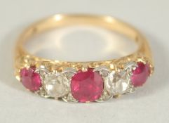 A FIVE STONE RUBY AND DIAMOND RING, Size J.