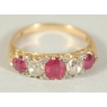 A FIVE STONE RUBY AND DIAMOND RING, Size J.