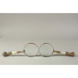 A PAIR OF GILT METAL AND ONYX MAGNIFYING GLASSES.