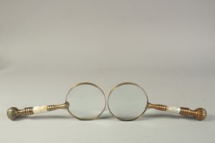 A PAIR OF GILT METAL AND ONYX MAGNIFYING GLASSES.
