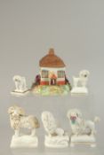 FOUR STAFFORDSHIRE TYPE POODLES, a similar ram and a ceramic cottage with wooden roof.