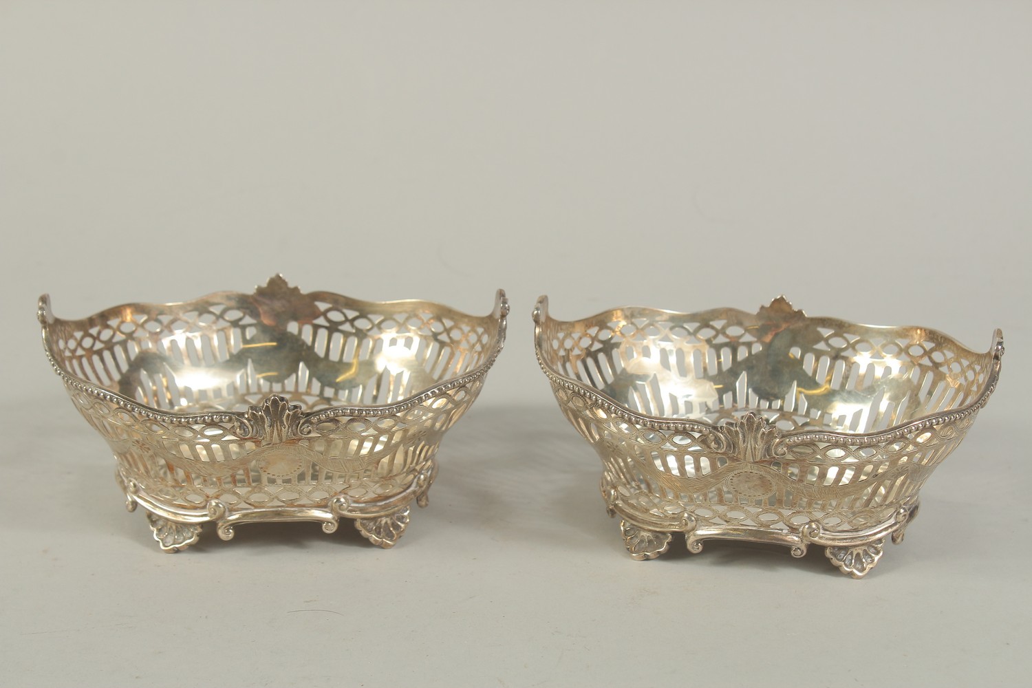 A PAIR OF VICTORIAN SILVER PIERCED OVAL BASKETS with bead edge on four shell feet. 6ins long. London - Image 2 of 6