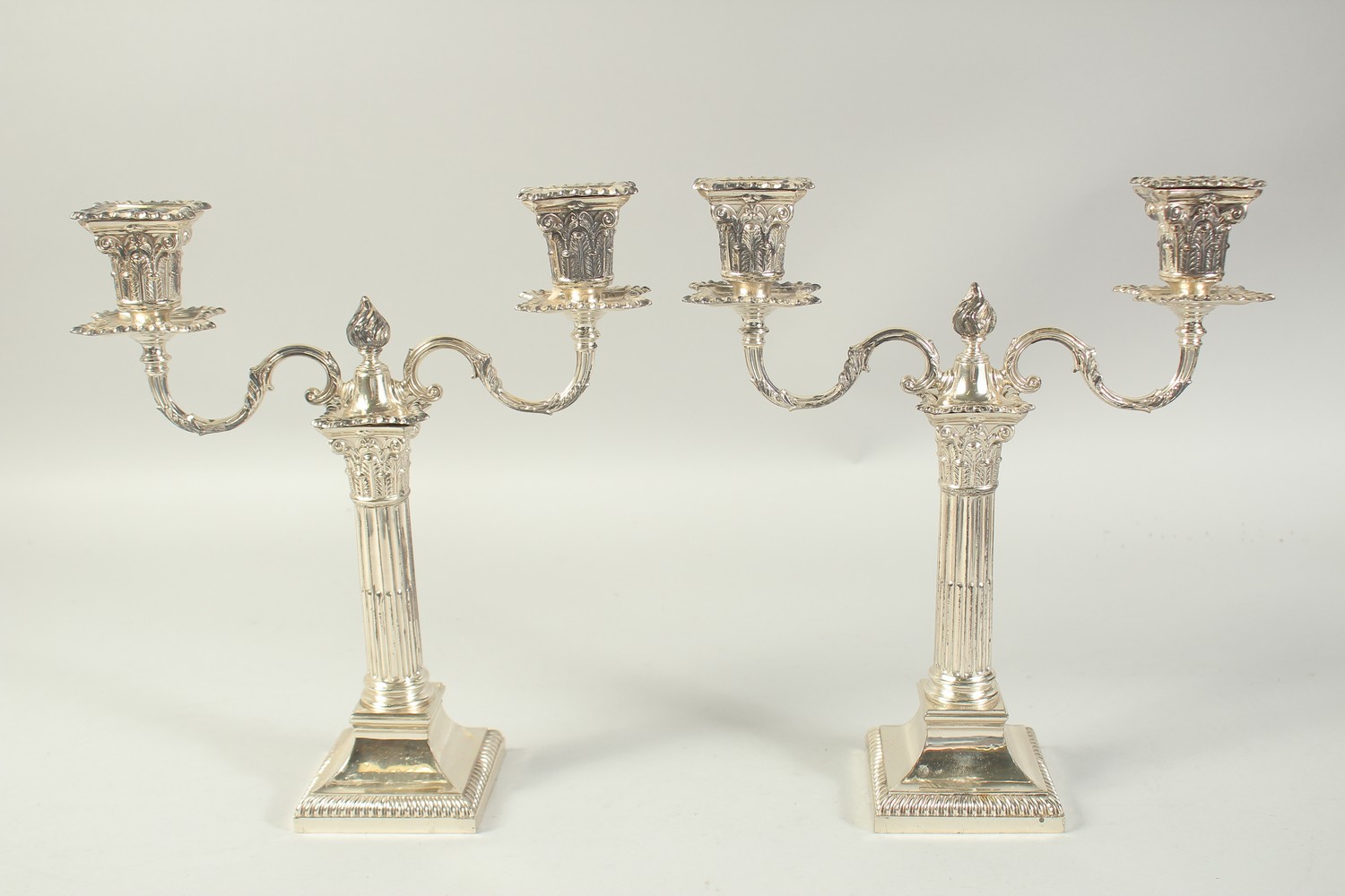 A GOOD PAIR OF TWO BRANCH SILVER CANDLESTICKS with coloums on square bases. 12ins high. London