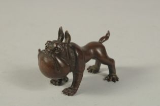 A BRONZE OKIMONO of a Dog. 8cms long.