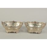 A PAIR OF VICTORIAN SILVER PIERCED OVAL BASKETS with bead edge on four shell feet. 6ins long. London