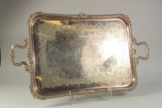 A LARGE PLATE TWO-HANDLED TEA TRAY with gadrooned and shell borders, and scroll handles. 30ins