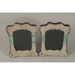 A PAIR OF ART DECO DESIGN SILVER AND BLUE ENAMEL BUTTERFLY PHOTOGRAPH FRAMES. 8 x 6ins.