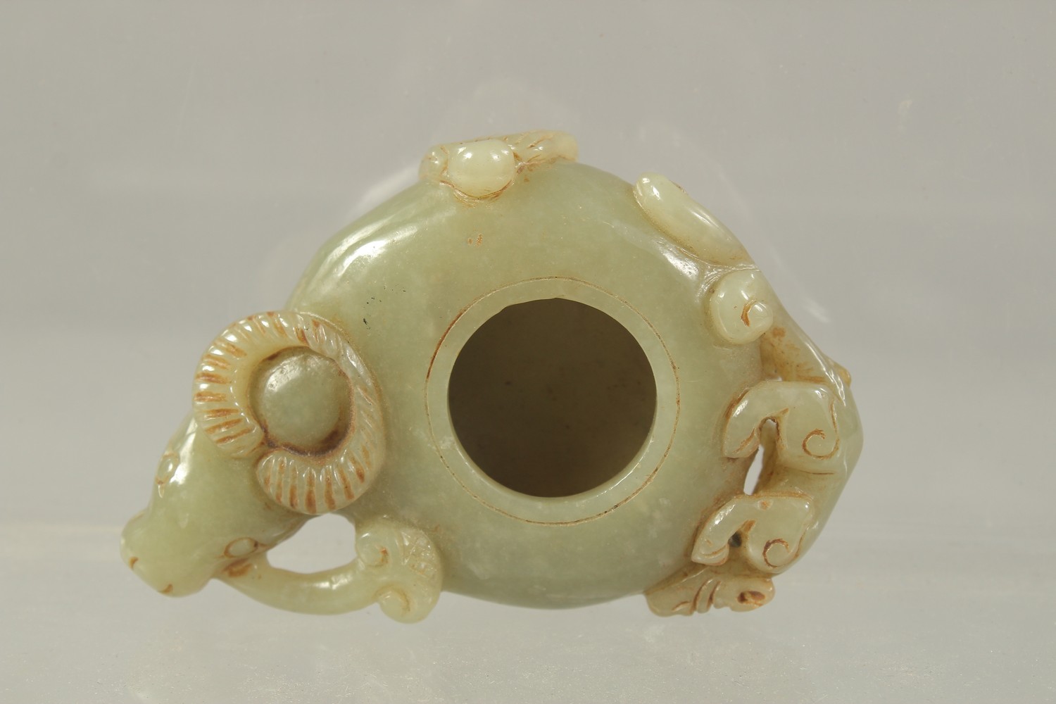 A GOOD CARVED JADE BRUSH POT of a bison. 8cms.