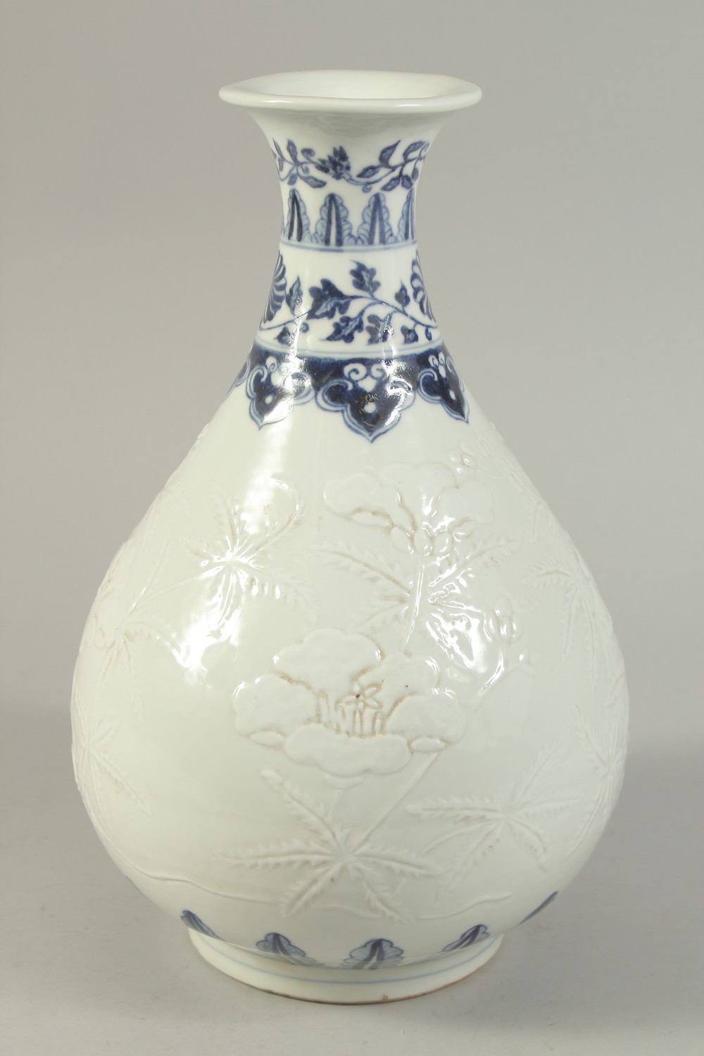 A CHINESE BLUE AND WHITE CARVED FLORAL YUHUCHUNPIN VASE. 32cms high. - Image 3 of 6