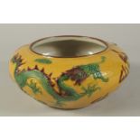 A CHINESE YELLOW GROUND CIRCULAR BOWL with dragons in relief. 10ins diameter.