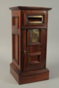 A GOOD MAHOGANY SQUARE POSTBOX, with brass letter flap, door and drawer below. 20ins high.