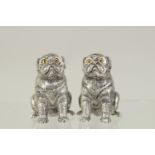 A PAIR OF SILVER PLATED DOG SALT AND PEPPERS. 1.75ins.