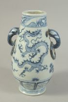 A CHINESE BLUE AND WHITE PORCELAIN TWIN-HANDLE DRAGON VASE. 27.5cms high.