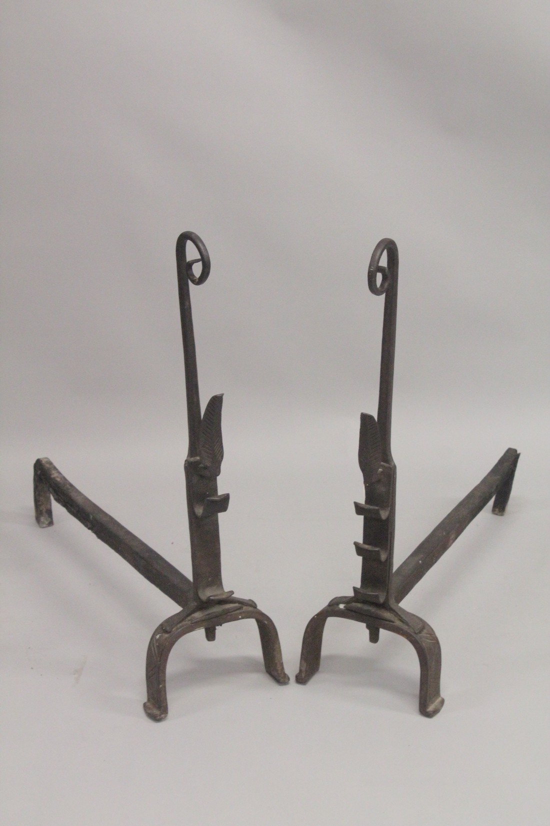 A GOOD PAIR OF EARLY WROUGHT IRON FIRE DOGS with curving tops. 31ins high, 28ins long