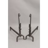 A GOOD PAIR OF EARLY WROUGHT IRON FIRE DOGS with curving tops. 31ins high, 28ins long