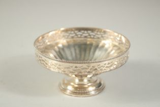 A CIRCULAR SILVER PIERCED BON BON DISH. 4.5ins diameter.