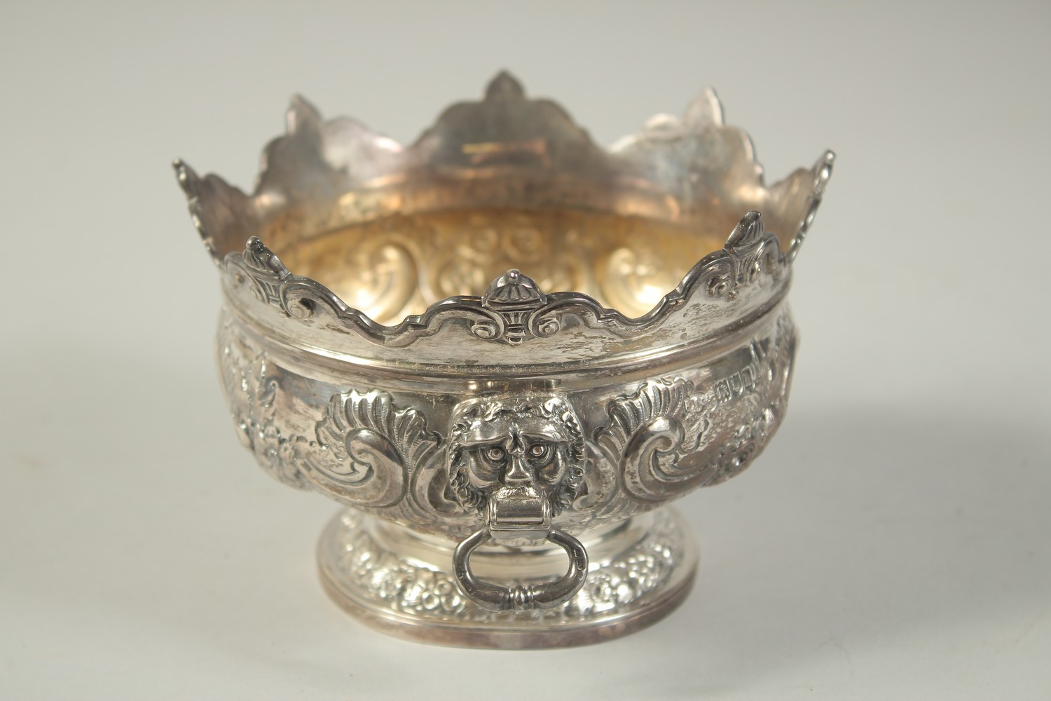 A GOOD SMALL SILVER MONTEITH BOX with repousse decoration and lion ring handles. 5.25ins diameter. - Image 2 of 7