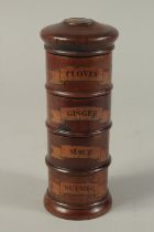 A WOODEN SPICE TOWER, cloves. ginger, mace and nutmeg. 8ins high.