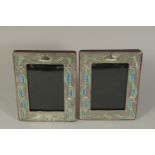 A PAIR OF ART DECO DESIGN SILVER AND BLUE ENAMEL PHOTOGRAPH FRAMES. 7.5 x 6ins.