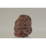 A CARVED HARDWOOD NETSUKE WITH A MAN AND DRAGON. Signed. 5cms.