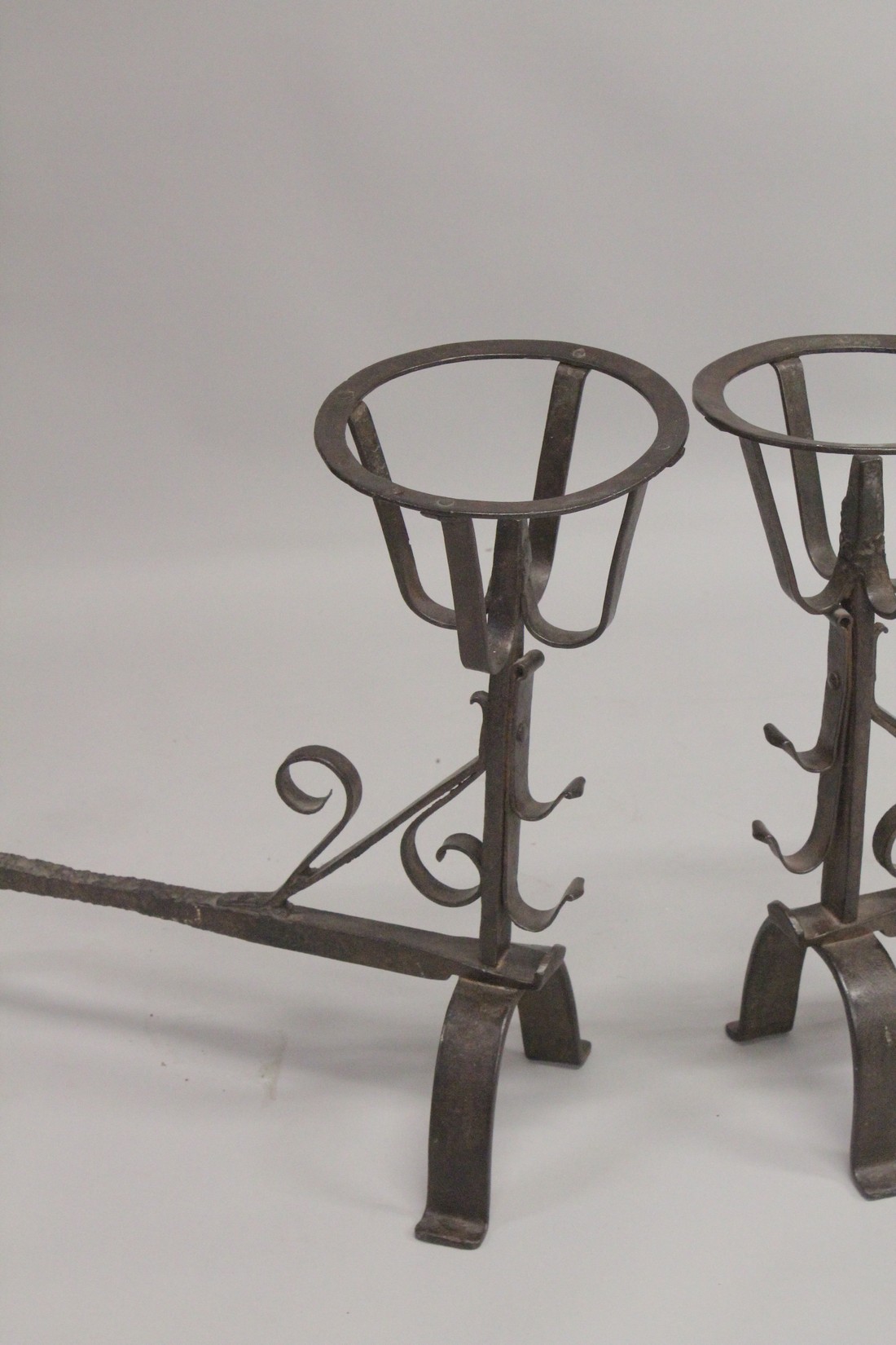 A GOOD PAIR OF EARLY WROUGHT IRON FIRE DOGS. 21ins high, 21ins long, with circle tops. - Image 2 of 3