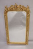 A GOOD GILTWOOD MIRROR with cupids and acanthus. 5ft high x 2ft 7ins wide.