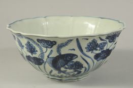 A CHINESE BLUE AND WHITE PETAL-FORM BOWL, painted with fish and aquatic flora. 22cms wide.