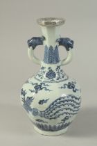 A CHINESE BLUE AND WHITE PORCELAIN TWIN-HANDLE VASE, with dragon and phoenix. 26cms high.