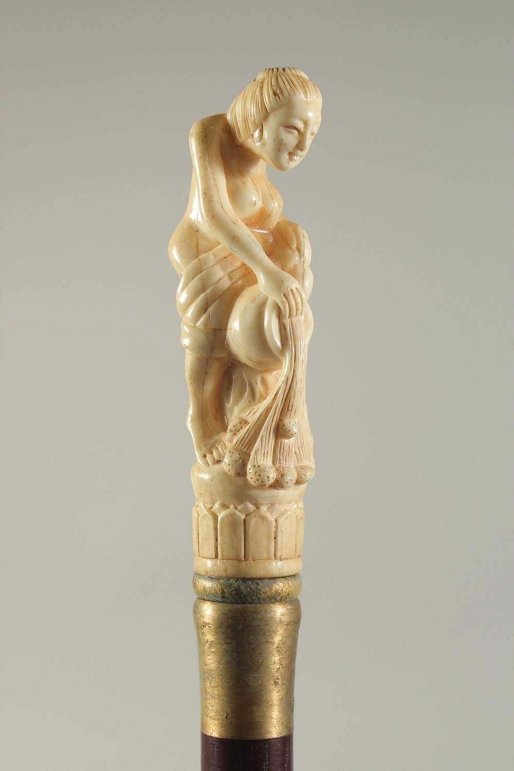 A CARVED BONE HANDLED WALKING STICK "SEMI-NUDE".