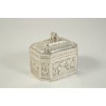 A SRI LANKAN SILVER METAL BOX AND COVER with animals and palm trees. 3.5ins.