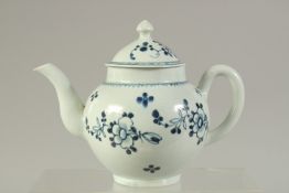 A LIVERPOOL PORCELAIN GLOBULAR TEAPOT AND COVER, painted with flowers in under glazed blue.