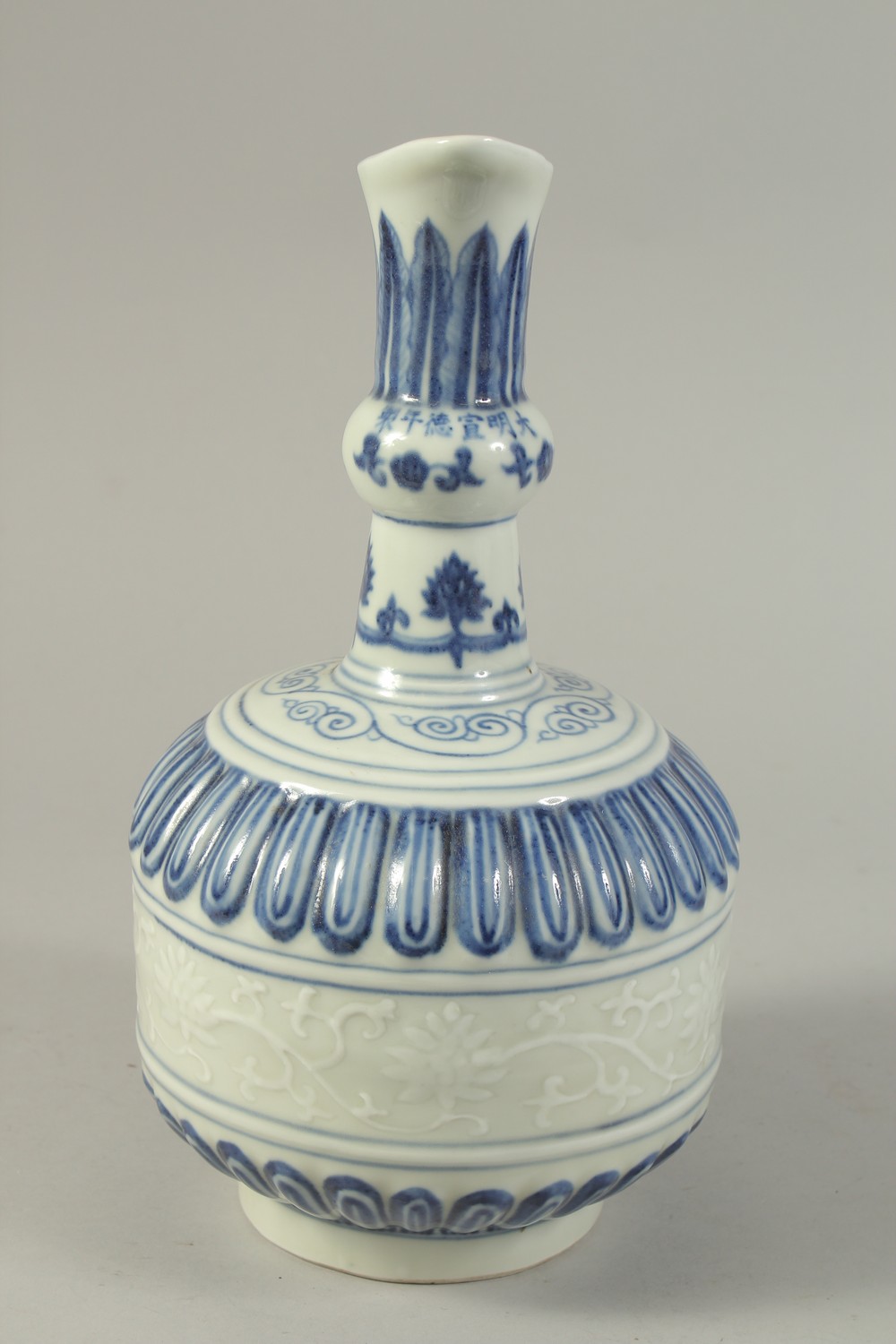 A CHINESE BLUE AND WHITE PORCELAIN EWER, with a band of carved floral decoration. 29cms high. - Image 2 of 6