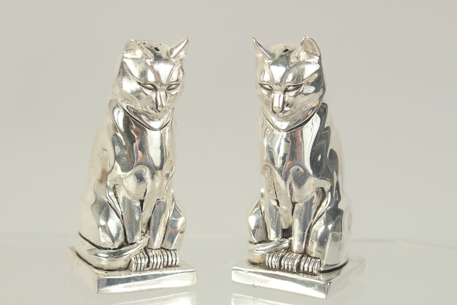 A PAIR OF SILVER PLATED DECO STYLE CAT SALT AND PEPPERS. 3ins