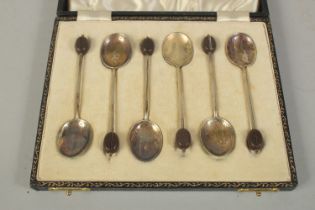 A SET OF SIX BEAN END COFFEE SPOONS with enamel bowls, cased.