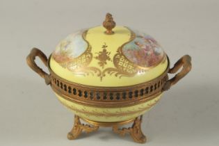 A SEVRES DESIGN YELLOW GROUND CIRCULAR PORCELAIN BOX AND COVER with classical scenes. 5ins high.