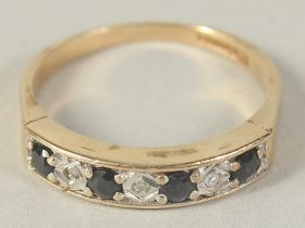 A 9CT GOLD SAPPHIRE AND DIAMOND HALF ETERNITY RING