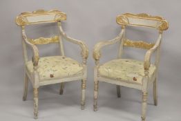 A PAIR OF CARVED, PAINTED AND PARCEL GILDED OPEN ARMCHAIRS, with floral upholstered overstuffed
