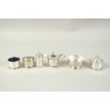 TWO SILVER MUSTARD POTS, a pepper pot, a small bowl and two salts. (6)