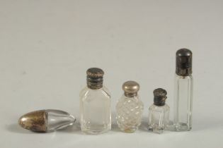 FIVE SMALL SILVER TOP GLASS SCENT BOTTLES.