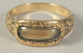 A GEORGE IV GOLD MOURNING RING. Engraved W.P.B. 1823.