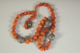 A GOOD ISLAMIC AMBER AND SILVER NECKLACE. 32ins long.