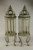 A LARGE PAIR OF COPPER ROUND LANTERNS on curving stands. 32ins high.