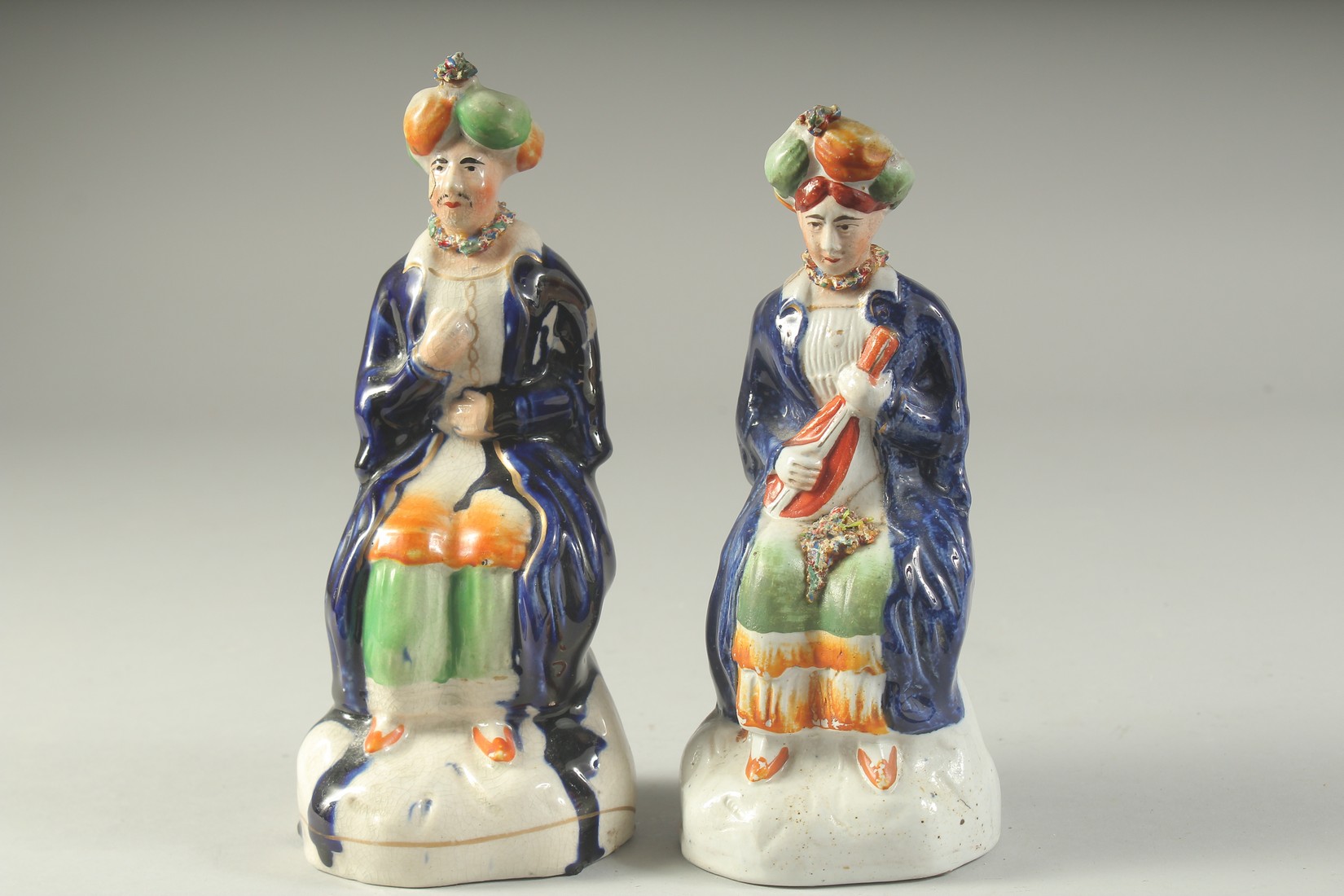 A PAIR OF STAFFORDSHIRE FIGURES OF TURKS. 7.5ins high.