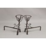 A GOOD PAIR OF EARLY WROUGHT IRON FIRE DOGS. 21ins high, 21ins long, with circle tops.